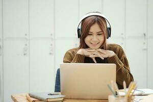 Young women study in front of the laptop computer at home. photo