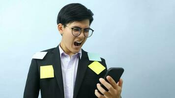 Portrait of surprised businessman holding mobile phone. photo