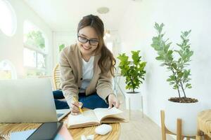 Young collage student using computer and mobile device studying online. photo