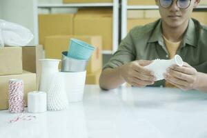 Young entrepreneur checking product preparing for delivery. photo