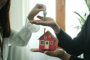 Businessman Holding House Keys. photo