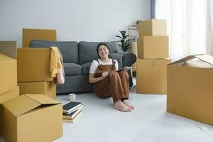 Young woman resting while moving into new home. photo