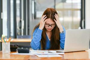 Businesswoman covering her face with both hands with the stress of work. photo