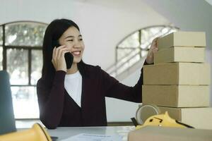 Female online business, store owner talking to customer using smartphone. photo