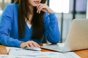 A female college student uses a computer to access the Internet for online learning. photo