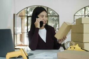 Female online business, store owner talking to customer using smartphone. photo