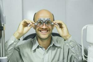 Man examining eyesight in optical clinic. photo