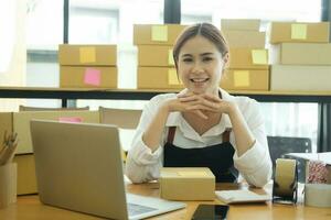 Asian businesswoman happy Home delivery service and working service mind. photo