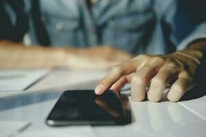 Close-up image of male hands using smartphone. photo