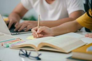 Young students campus helps friend catching up and learning. photo