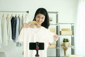 Businesswoman giving important pieces of advice while streaming video for women's clothing. photo