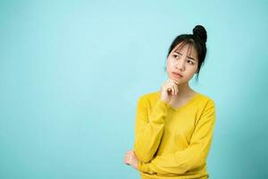 Young Woman poses suspiciously in the studio concept. photo