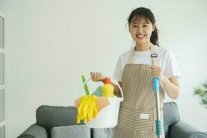 Young woman holding cleaning equipments ready for cleaning. photo