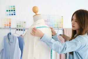 Young woman and fashion designer is create the new collections of cloth. photo