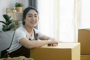 Happy woman smiling at home during move with boxes photo