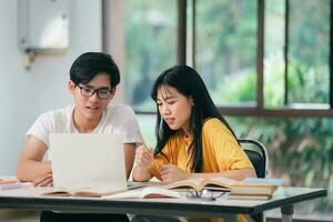 Young asian students campus helps friend catching up and learning. photo