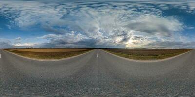 spherical 360 hdri panorama on old asphalt road with cracks with clouds and sun on evening blue sky in equirectangular seamless projection, as sky replacement in drone panoramas, game development photo