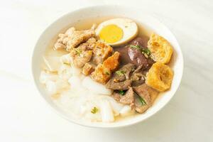 paste of rice flour or boiled Chinese pasta square in clear soup photo