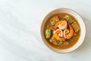 Sour soup made of Tamarind Paste with Shrimps and Vegetable Omelet photo