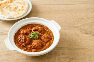 chicken tikka masala spicy curry meat food with roti or naan bread photo