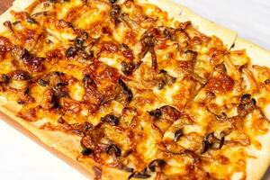 tart flambe mushroom pizza on wood board photo