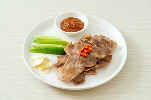 grilled pork neck sliced on plate photo