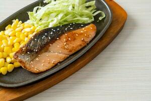 grilled salmon fillet steak on hot plate photo