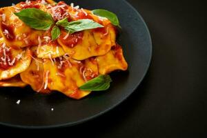 Ravioli with tomato sauce and basil photo
