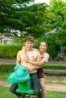 Asian couple love smiling and sitting on rockky horse photo