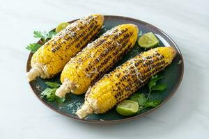 barbecue and grilled corn with cheese and lime photo