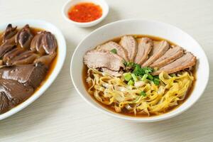 egg noodles with stewed duck in brown soup photo