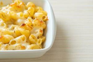 American mac and cheese, macaroni pasta in cheesy sauce photo