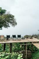 chair on balcony with mountain hill and foggy background photo