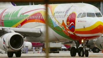 PHUKET, THAILAND DECEMBER 05, 2016 - Airbus A320 of Bangkok Air Guilin Livery taxiing, view through Phuket airport fence. Tourism and travel concept video