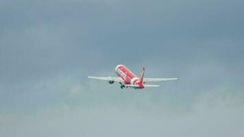 PHUKET, THAILAND DECEMBER 02, 2016 - Rear view of passenger plane Airbus A320 of AirAsia fly away, departure at Phuket Airport. Tourism and travel concept video