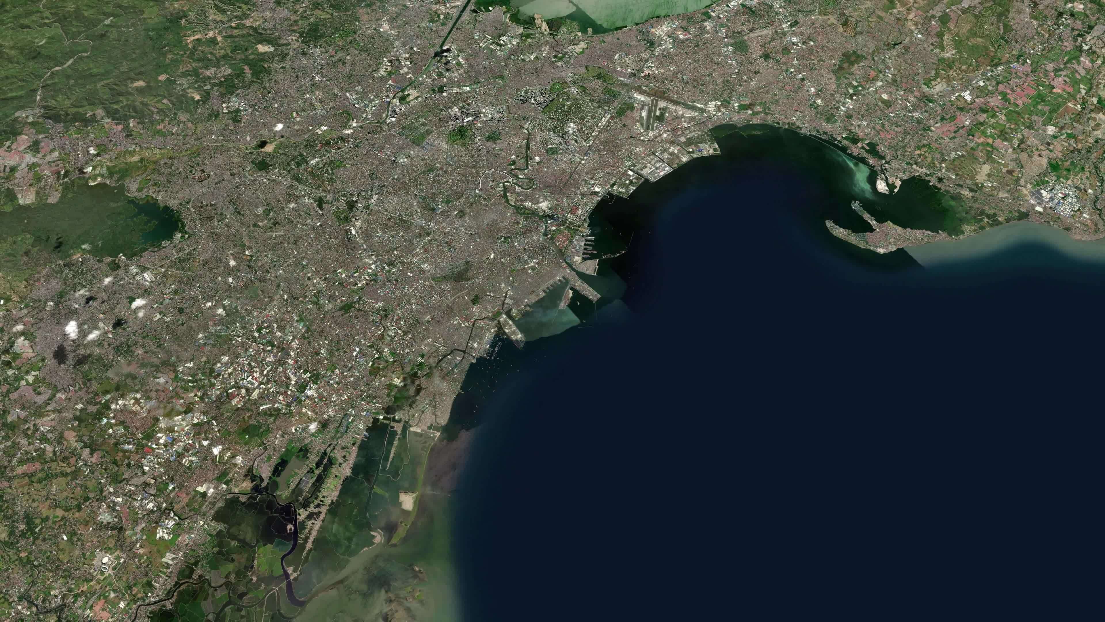 Satellite Manila map background loop. Spinning around Philippines city air footage. Seamless