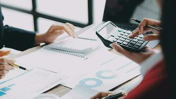 Financial analysts analyze business financial reports on a digital tablet planning investment project during a discussion at a meeting of corporate showing the results of their successful teamwork. video