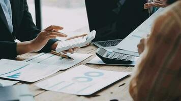 Financial analysts analyze business financial reports on a digital tablet planning investment project during a discussion at a meeting of corporate showing the results of their successful teamwork. video