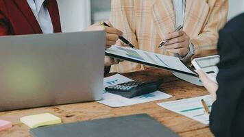 Financial analysts analyze business financial reports on a digital tablet planning investment project during a discussion at a meeting of corporate showing the results of their successful teamwork. video