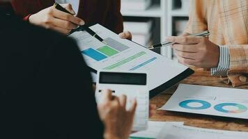 Financial analysts analyze business financial reports on a digital tablet planning investment project during a discussion at a meeting of corporate showing the results of their successful teamwork. video