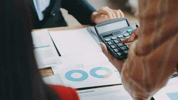 Financial analysts analyze business financial reports on a digital tablet planning investment project during a discussion at a meeting of corporate showing the results of their successful teamwork. video