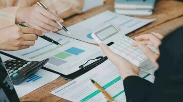 Financial analysts analyze business financial reports on a digital tablet planning investment project during a discussion at a meeting of corporate showing the results of their successful teamwork. video