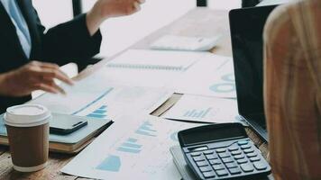 Financial analysts analyze business financial reports on a digital tablet planning investment project during a discussion at a meeting of corporate showing the results of their successful teamwork. video