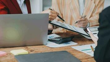 Financial analysts analyze business financial reports on a digital tablet planning investment project during a discussion at a meeting of corporate showing the results of their successful teamwork. video
