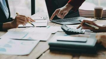 Financial analysts analyze business financial reports on a digital tablet planning investment project during a discussion at a meeting of corporate showing the results of their successful teamwork. video