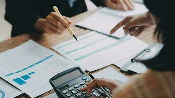 Financial analysts analyze business financial reports on a digital tablet planning investment project during a discussion at a meeting of corporate showing the results of their successful teamwork. video