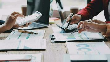 Financial analysts analyze business financial reports on a digital tablet planning investment project during a discussion at a meeting of corporate showing the results of their successful teamwork. video