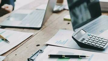 Financial analysts analyze business financial reports on a digital tablet planning investment project during a discussion at a meeting of corporate showing the results of their successful teamwork. video