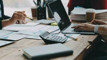 Financial analysts analyze business financial reports on a digital tablet planning investment project during a discussion at a meeting of corporate showing the results of their successful teamwork. video