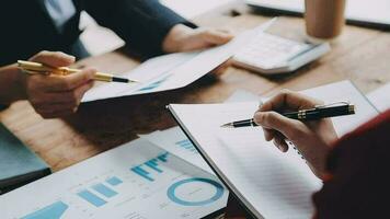 Financial analysts analyze business financial reports on a digital tablet planning investment project during a discussion at a meeting of corporate showing the results of their successful teamwork. video